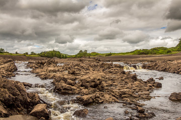The Water of Ken river flowing through the original channel, Dalry, Scotland