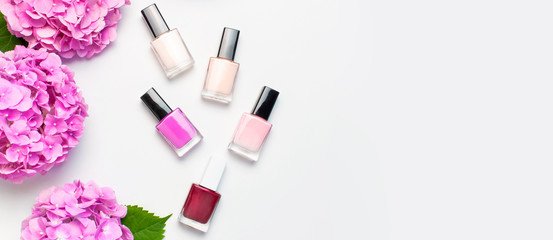 Nail polish, Decorative cosmetics. Set of different varnishes for manicure nails on light...