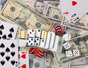 American dollars, banknotes, cash money with playing cards, dominoes and gambling dice, background and texture