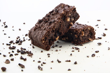 Brownie pieces on white background. Delicious chocolate pie.