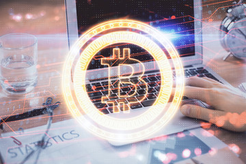 Blockchain theme hologram with man working on computer on background. Concept of crypto chain....