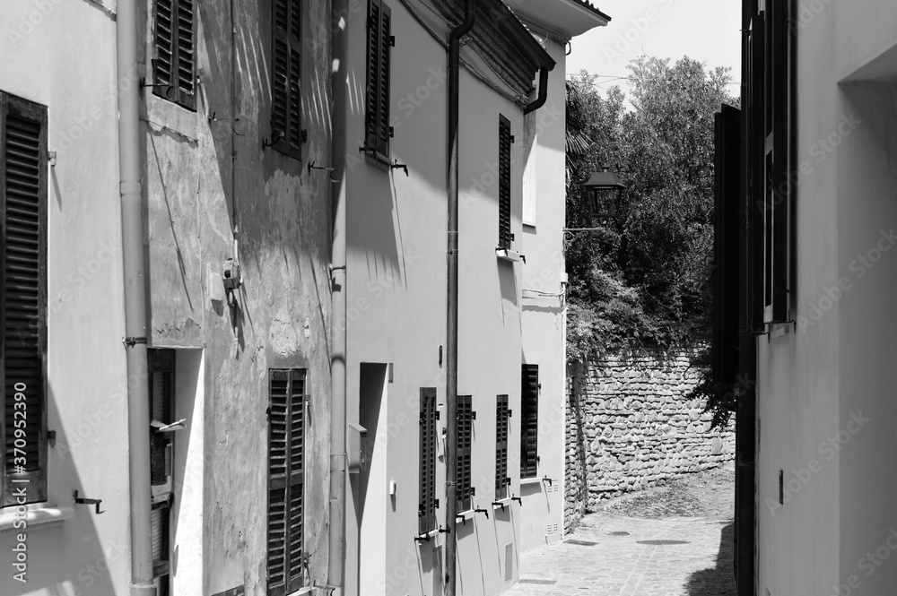 Wall mural Alley of a small Italian village with old brick houses (Pesaro, Italy, Europe)