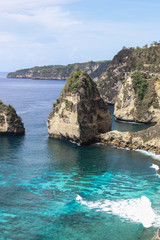 The beautiful Diamond Beach on Nusa Penida Island, Bali, Indonesia. Amazing  view, white sand beach with rocky mountains and azure lagoon with clear water of Indian Ocean 