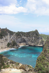 The beautiful Diamond Beach on Nusa Penida Island, Bali, Indonesia. Amazing  view, white sand beach with rocky mountains and azure lagoon with clear water of Indian Ocean 