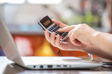 e-commerce concept. The hand of the person holding the calculator and entering the data.