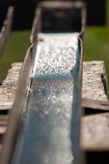 wet rusty channel on a wooden workbench
