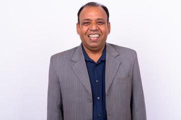 Portrait of happy mature overweight Indian businessman in suit
