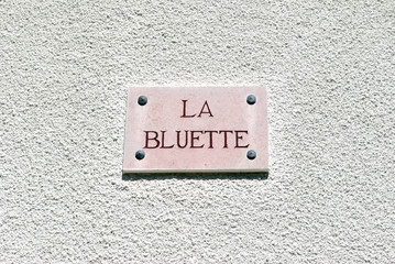 Close Up of French House Name Plaque Translated as 'The Cornflower' 