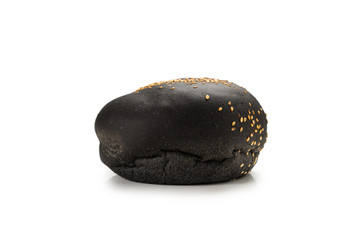 Black burger bread isolated on white.