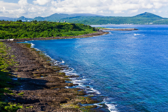 Coastal reef and sea waves with blue sky in the Kending National Park of Pingtung, Taiwan.
