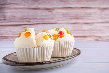 Thai steamed cupcakes topped with dry fruit on plate