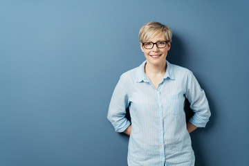 Smiling woman in blue shirt on blue background