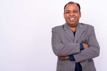 Portrait of happy mature overweight Indian businessman in suit