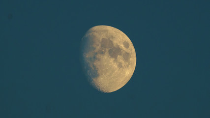 A photo of the moon at dusk