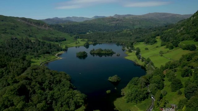 4K:  Drone Aerial Clip of Rydal Water Lake in the English Lake District, Cumbria, UK. Approach shot in Summer with Blue Sky. Stock Video Clip Footage