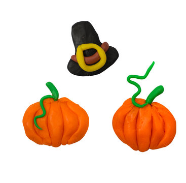 Pumpkins and thanksgiving hat isolated on white background. Plasticine kids holiday artwork.