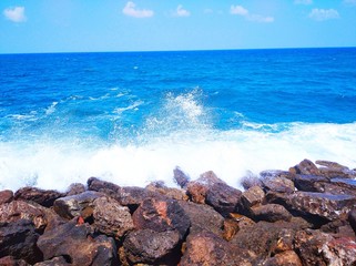 Beautifull small waves heating the small rocks at old port of Chania in Crete, Greece