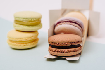 Several colorful macaroon cakes on a colored background