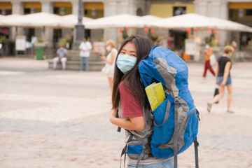 new normal backpacker girl in holidays travel - young happy and attractive Asian Korean woman in face mask enjoying city tour cheerful after covid19 lockdown