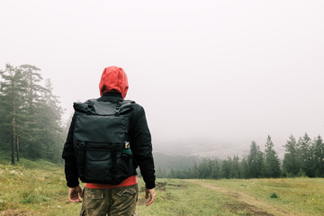 Nature explorer enjoying the view of  a foggy mountain range
