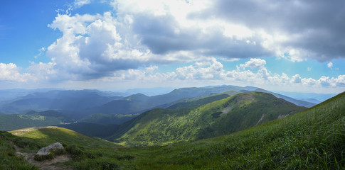Naklejka na ściany i meble Panorama of the Carpathian mountains. Hoverla peak on a sunny day with blue sky and white clouds