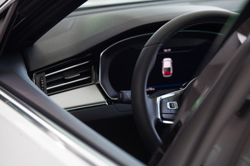 Obraz na płótnie Canvas view of the steering wheel and car dashboard through the window