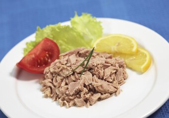 Can of Tuna Fish, Tuna in a Plate with Salad, Tomatoes and Lemon