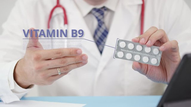Vitamin b9 blister pack with tablets in doctor's hand