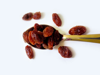 Healthy Dry Raisin with Spoon on white isolated Background