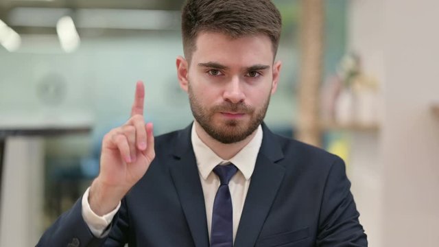 Young Businessman saying No by Finger Sign