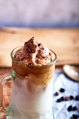 glass of dalgona coffee with chocolate and on a rustic background