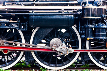 Fototapeta premium Steam Train car wheels closeup photo