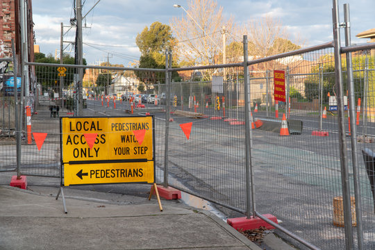 traffic management and road works signs with temporary fencing on a street in Melbourne