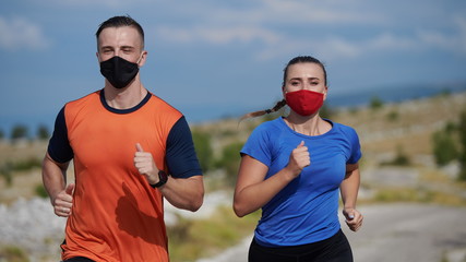 Fototapeta premium couple running in nature wearing mask