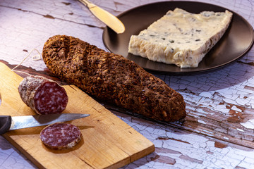 closeup of salami sausages on wooden board