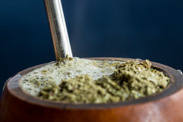 Close-up of steaming yerba mate tea (Ilex paraguariensis) infusion in its customary cup. Drinking mate is a popular practice in Paraguay, Uruguay, Argentina and parts of Brazil