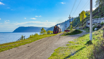 locomotive moves along the railway around lake Baikal