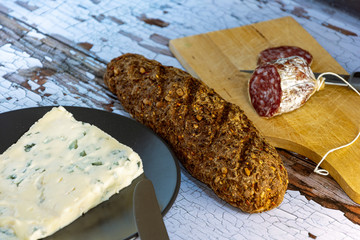 closeup of salami sausages on wooden board 