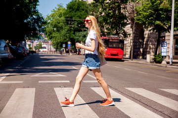 Fototapeta na wymiar Happy young woman walking in the city
