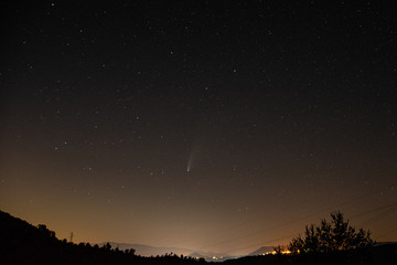Fototapeta premium night sky with stars and neowise comet with a landscape
