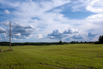 a rural landscape with cut fields and a dramatically brilliant blue sky