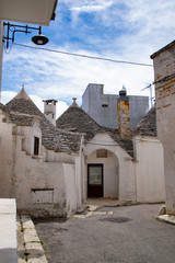 Fototapeta na wymiar South of the Italy, alberobello with blue sky and the trulli in background
