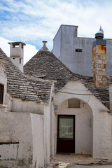 Fototapeta na wymiar alberobello with blue sky in background and the trulli in foreground