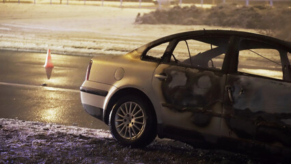 car accident. wrecked and burned vehicle on the road on the coast. High quality photo