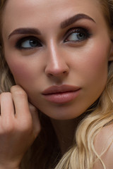 Fototapeta premium Beauty Woman face with hand Portrait. Beautiful model Girl with Perfect Fresh Clean Skin color lips purple red. Blonde long hair Youth and Skin Care Concept. Isolated on a white background