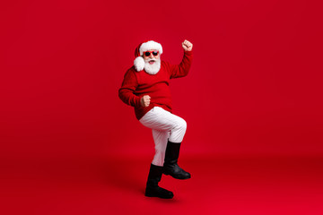 Fototapeta na wymiar Full size photo of crazy old man in santa claus headwear raise fists win shopping season fairy x-mas sale wear pants trousers boots isolated over bright shine color background