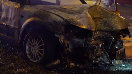 Front view of the car burned after the serious car accident at night in winter. High quality photo