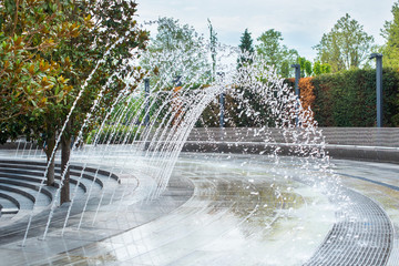 beautiful fountain in Krasnodar. you can pass under the arc of water. a splash cascade forms a...