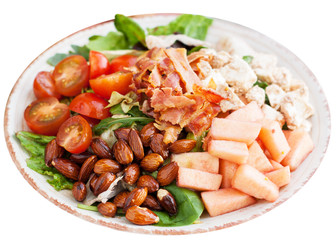 Salad with apple, bacon, cashew cheese, tomatoes, almonds