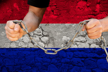 male hands break the iron chain, a symbol of bondage,protest against the background of the national...